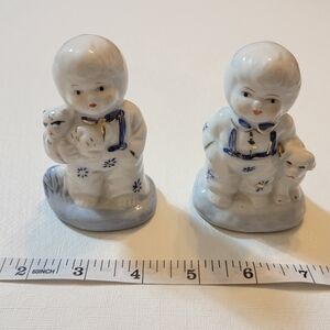 Vintage Chinese pair of blue and white figurines.  Boy w/ dog Girl w/ kitten